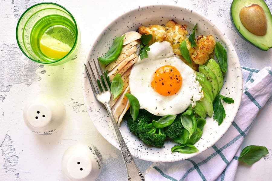 A healthy meal of eggs, vegetables, avocado and lemonade