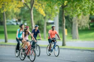 Teens cycling and geared up for a physical activity