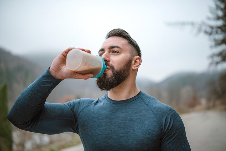A fit young man drinking protein shake