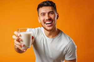 A health-conscious man with a glass of milk