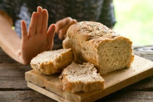 A female on a gluten free diet is refusing to eat bread