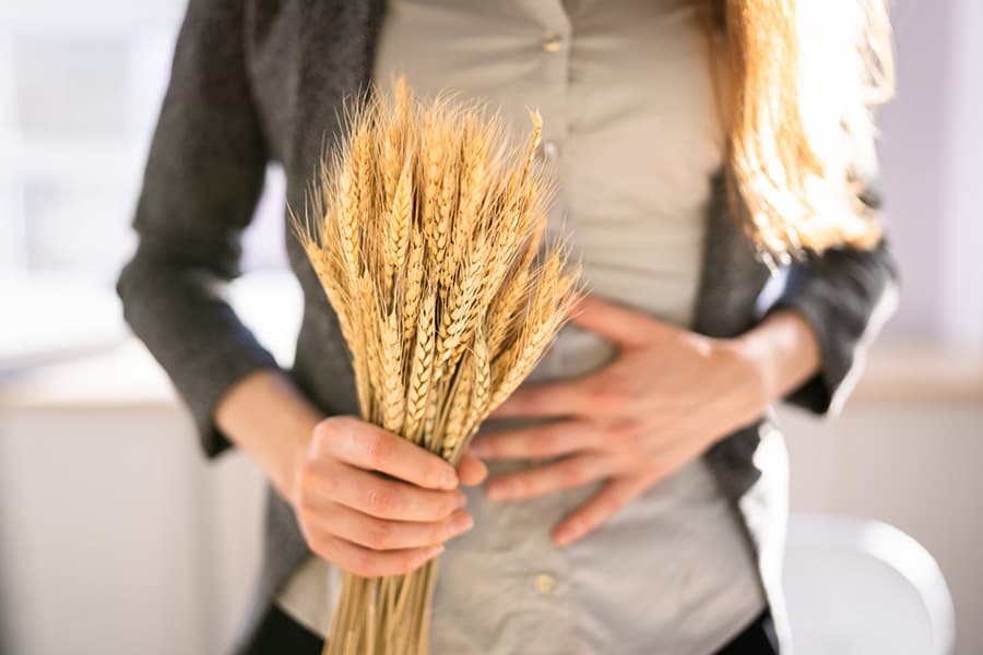 A woman holding wheat strands