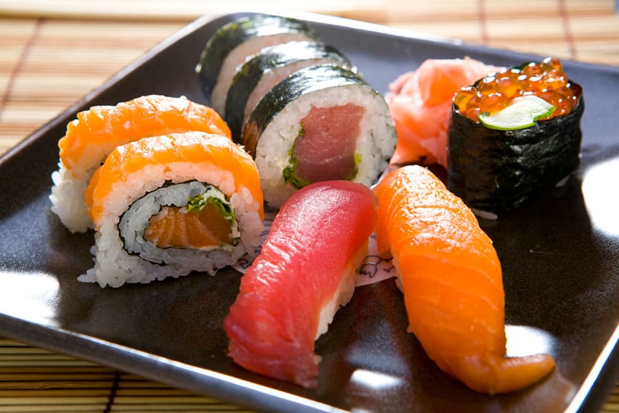 Salmon and Tuna sushi with soy sauce in a plate