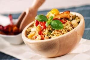 A bowl full of couscous with vegetables