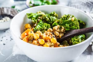 A bowl full of low carb vegan items including chickpeas, chie seeds, and more.