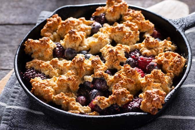 A cast iron pan with vegan blackberry crumble.