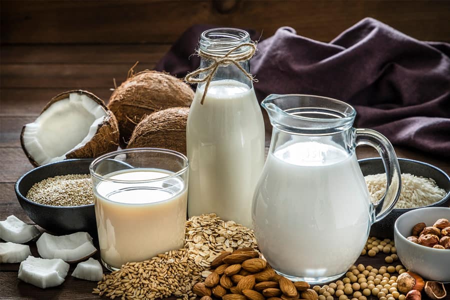 vegan calcium sources like milk, almonds, and more are displayed in the image