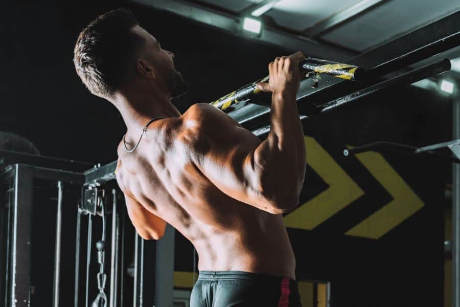 A fitness freak is doing pull-ups
