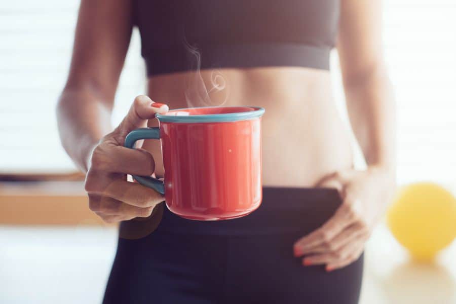 A girl is holding a cup of hot coffee