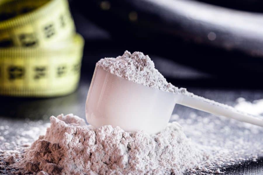 Creatine powder in a scoop