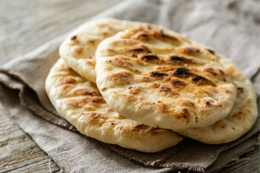 Baked pita bread is placed on a napkin