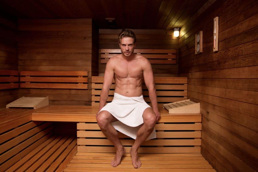 A man is having his sauna bath after his workout session.